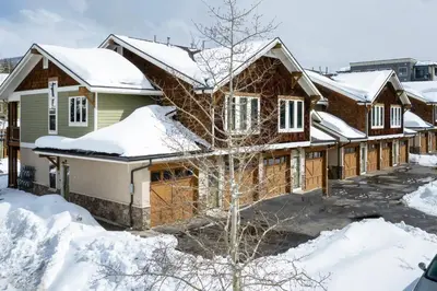 a house is covered in snow at Telemark Townhomes Unit 514 in Winter Park