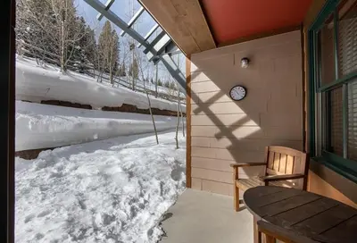 a clock on the side of a building with snow at Secluded Condo with Corridor Ski Trail View - Zephyr Mountain Lodge Premium Unit 1201 condo in Winter Park