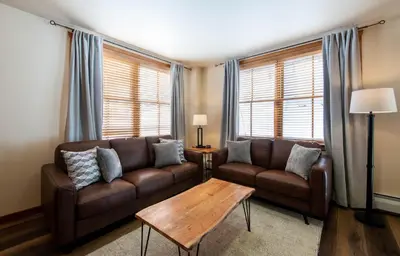 a living room with a couch and a coffee table at Secluded Condo with Corridor Ski Trail View - Zephyr Mountain Lodge Premium Unit 1201 condo in Winter Park