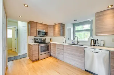 a kitchen with wooden cabinets and a sink at 13 Mi to Dtwn Denver Arvada Townhome with Deck in Arvada