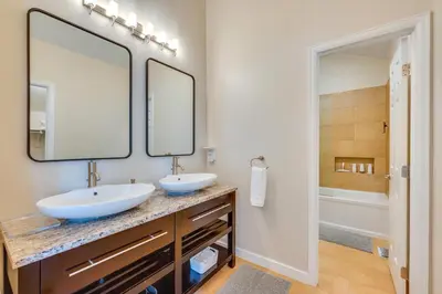 a bathroom with two sinks and a large mirror at 13 Mi to Dtwn Denver Arvada Townhome with Deck in Arvada