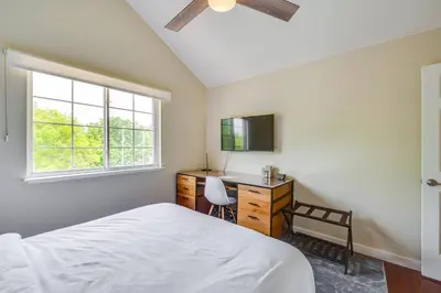 a bedroom with a bed and a desk and a window at 13 Mi to Dtwn Denver Arvada Townhome with Deck in Arvada