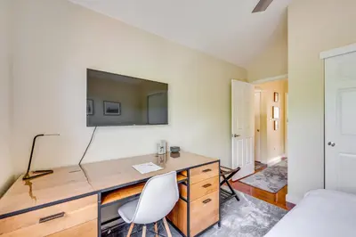 a bedroom with a desk and a tv on a wall at 13 Mi to Dtwn Denver Arvada Townhome with Deck in Arvada