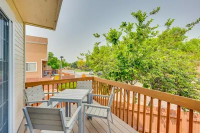 a table and chairs on a balcony with a street at 13 Mi to Dtwn Denver Arvada Townhome with Deck in Arvada