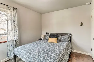 a bedroom with a bed and a window at 3 Mi to Empower Field Denver Home with Fire Pit in Denver