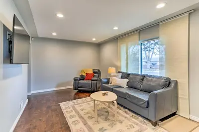 a living room with a couch and a table at 3 Mi to Empower Field Denver Home with Fire Pit in Denver