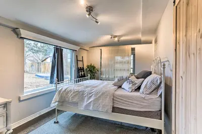 a bed in a room with a window at 3 Mi to Empower Field Denver Home with Fire Pit in Denver