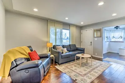 a living room with a couch and a table at 3 Mi to Empower Field Denver Home with Fire Pit in Denver