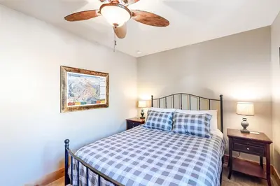 a bedroom with a bed and a ceiling fan at High Country Nest in Winter Park- Unit 16 in Winter Park
