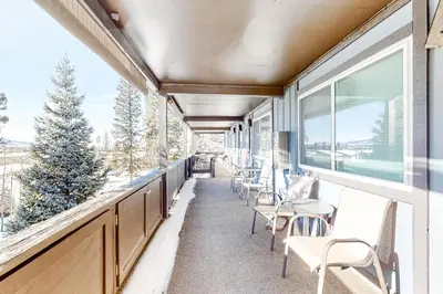a balcony with chairs and tables and windows at High Country Nest in Winter Park- Unit 16 in Winter Park