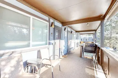 a room with windows and a table and chairs at High Country Nest in Winter Park- Unit 16 in Winter Park