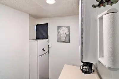 a small kitchen with a refrigerator in a room at Vacation Rental Near Boyd Lake, Colorado! in Loveland