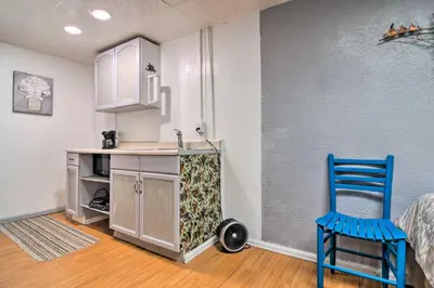 a kitchen with a table and a blue chair in a room at Vacation Rental Near Boyd Lake, Colorado! in Loveland