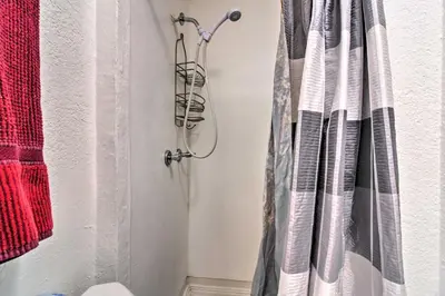 a shower curtain is hanging in a bathroom at Vacation Rental Near Boyd Lake, Colorado! in Loveland