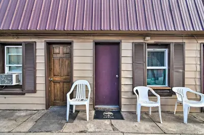 three chairs sitting outside of a house with a purple door at Vacation Rental Near Boyd Lake, Colorado! in Loveland