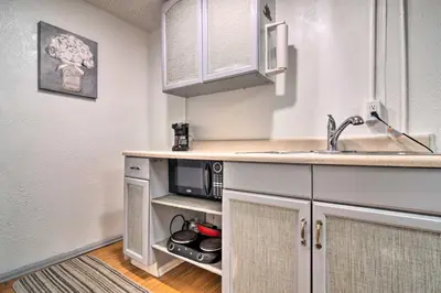 a kitchen with a sink and a microwave at Vacation Rental Near Boyd Lake, Colorado! in Loveland