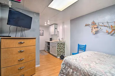 a bedroom with a bed and a dresser with a tv on it at Vacation Rental Near Boyd Lake, Colorado! in Loveland