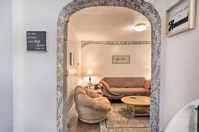 a hallway into a living room with a couch and a table at Pet-Friendly Loveland Vacation Rental! in Loveland