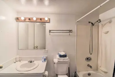 a white bathroom with a sink and a shower at Vacation Rental in Loveland 1 Mi to Downtown! in Loveland