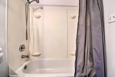 a bathroom with a shower and a white tub at Vacation Rental in Loveland 1 Mi to Downtown! in Loveland