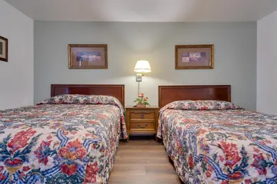 a hotel room with two beds and a night stand at Loveland Vacation Rental Pets Welcome in Loveland