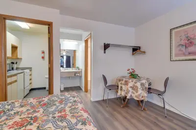 a bedroom with a table and a bed and a kitchen at Loveland Vacation Rental Pets Welcome in Loveland