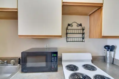 a kitchen with a microwave and a stove at Loveland Vacation Rental Pets Welcome in Loveland