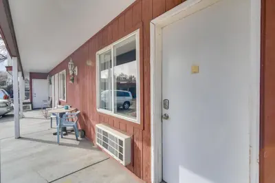 a building with a porch with a table and a window at Loveland Vacation Rental Pets Welcome in Loveland
