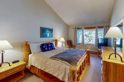a bedroom with a bed and two lamps and a television at Rocky Mountain Living in Dillon