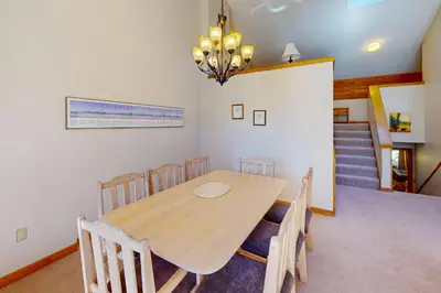 a dining room with a wooden table and chairs at Rocky Mountain Living in Dillon
