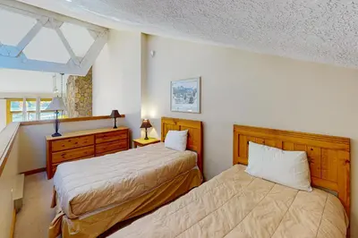 a bedroom with two beds and a dresser at Rocky Mountain Living in Dillon