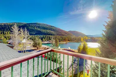 a balcony with a view of a lake and mountains at Rocky Mountain Living in Dillon