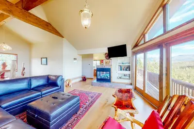 a living room with a blue couch and a fireplace at The Retreat at Grand Lake in Grand Lake