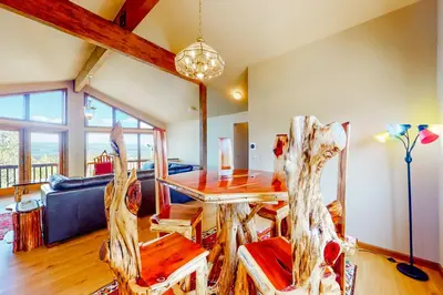 a living room with a wooden table and chairs at The Retreat at Grand Lake in Grand Lake
