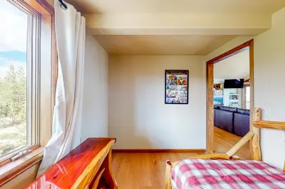 a room with a bed and a window at The Retreat at Grand Lake in Grand Lake