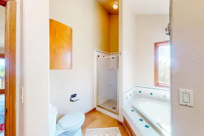 a bathroom with a toilet and a bath tub at The Retreat at Grand Lake in Grand Lake