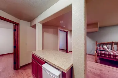 a kitchen with a counter and a bed in a room at The Retreat at Grand Lake in Grand Lake