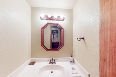 a bathroom with a sink and a mirror at The Retreat at Grand Lake in Grand Lake