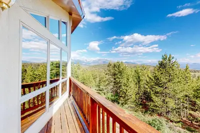 a balcony with a view of the mountains at The Retreat at Grand Lake in Grand Lake