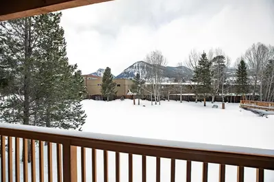 a snow covered yard with trees and buildings at Lagoon Raven Townhome: Great Location, Amenities in Frisco