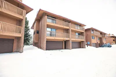 an apartment building with a parking lot in front of it at Lagoon Raven Townhome: Great Location, Amenities in Frisco