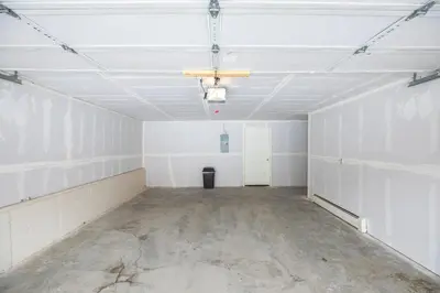 an empty room with white walls and concrete floors at Lagoon Raven Townhome: Great Location, Amenities in Frisco