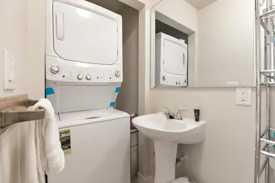 a small bathroom with a sink and a washing machine at Lagoon Raven Townhome: Great Location, Amenities in Frisco