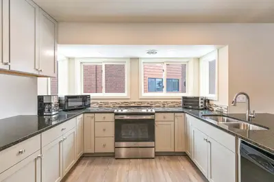 a kitchen with white cabinets and stainless steel appliances at Lagoon Raven Townhome: Great Location, Amenities in Frisco