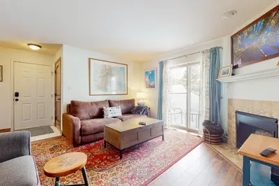 a living room with a couch and a fireplace at Frisco Home Base in Frisco