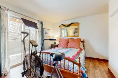 a bedroom with a bed and a bike in front of it at Frisco Home Base in Frisco