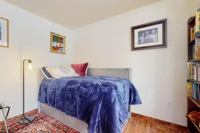 a bedroom with a bed with a blue blanket on it at Frisco Home Base in Frisco