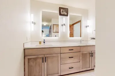 a bathroom with a sink and a mirror at Frisco Home Base in Frisco