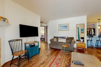a living room with a couch and a flat screen tv at Frisco Home Base in Frisco