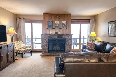 a living room with a couch and a fireplace at Griffons Nest in Silverthorne
